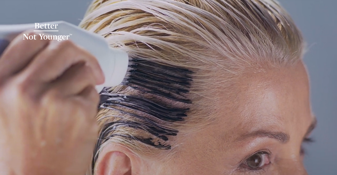 A woman detoxing her scalp with An Activated Charcoal Scalp Cleanser Called New Dawn By Better Not Younger