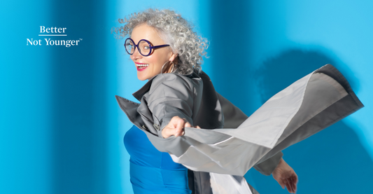 In this 10 Hair-Care Resolutions to Ring in the New Year, BNY features a beautiful woman with short gray curly hair having fun, wearing a blue dress and having fun on a blue background.