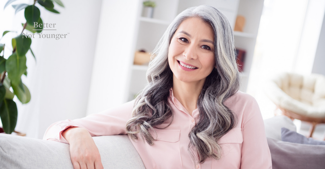 Beautiful woman with gray hair sitting and smiling gracefully | Better Not Younger