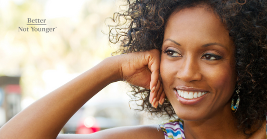 A woman with beautiful black curly hair smiling