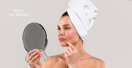 A woman looking her menopausal acne in the mirror 