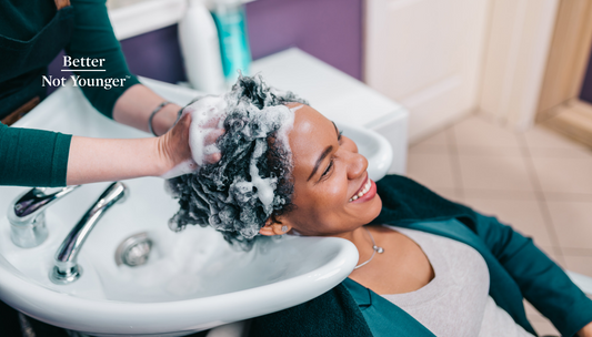 Better Not Younger features an woman having her hair washed at the salon. An imagine to illustrate the article about the difference between a shampoo and a hair conditioner.