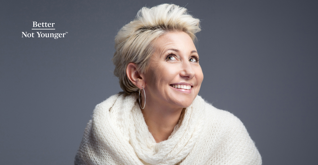 Better Not Younger features a short blonde hair woman looking up while smiling. 