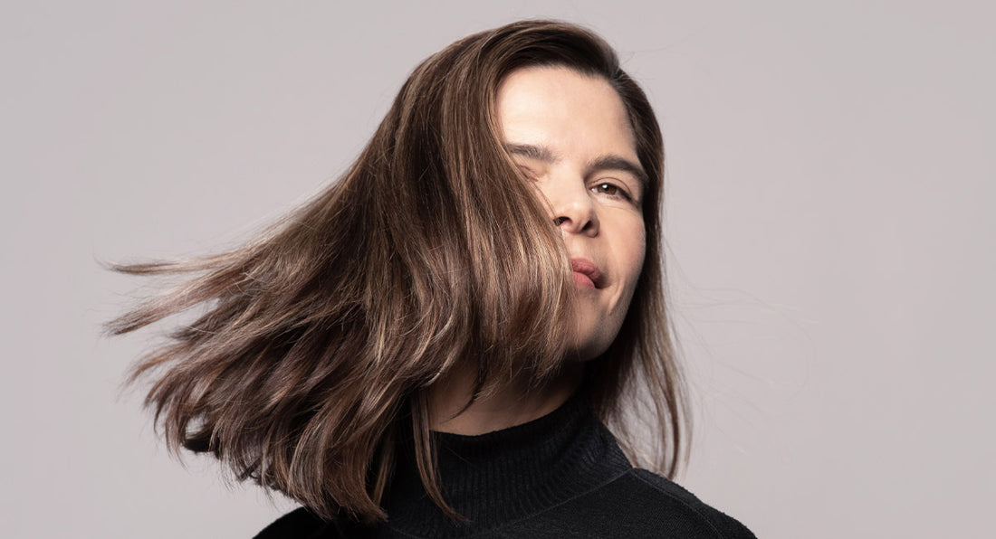 A woman over 40 is smiling and feels happy about the results of the hair mask by better not younger. 