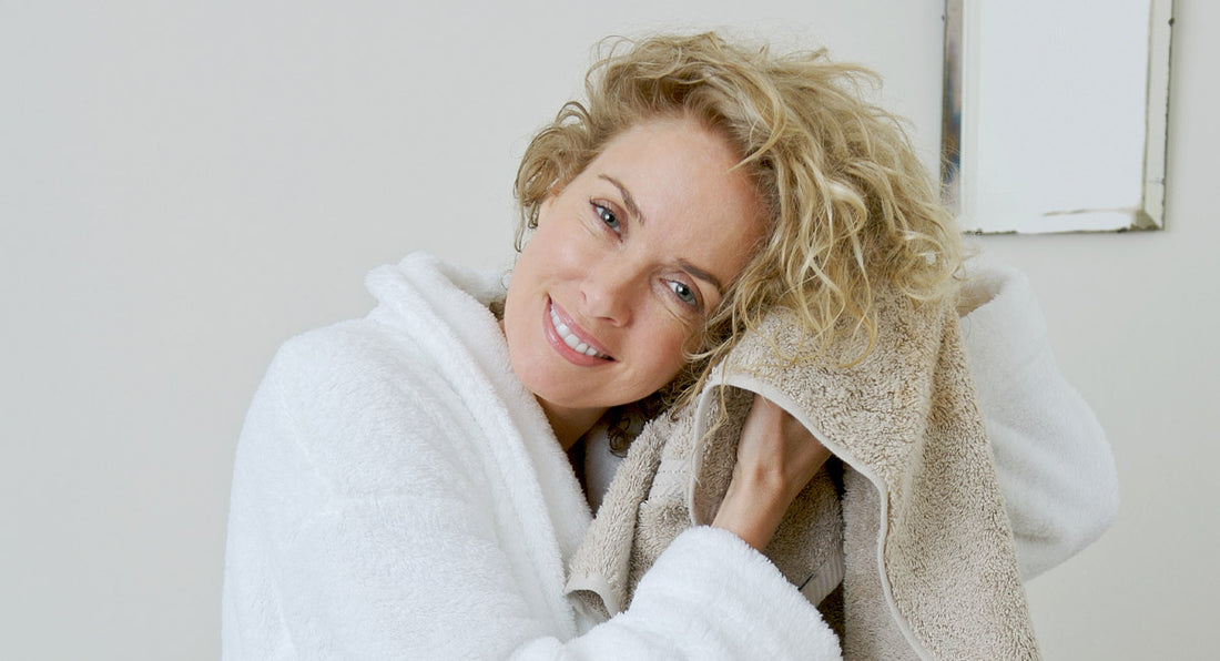 a happy woman over 40 years old feels happy about scalp benefits of cold water for her hair in the winter