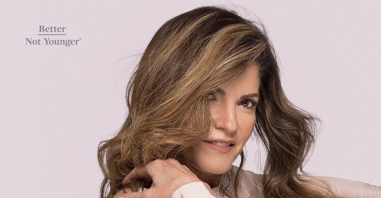 Middle age woman with amazing hair volume smiling to the camera