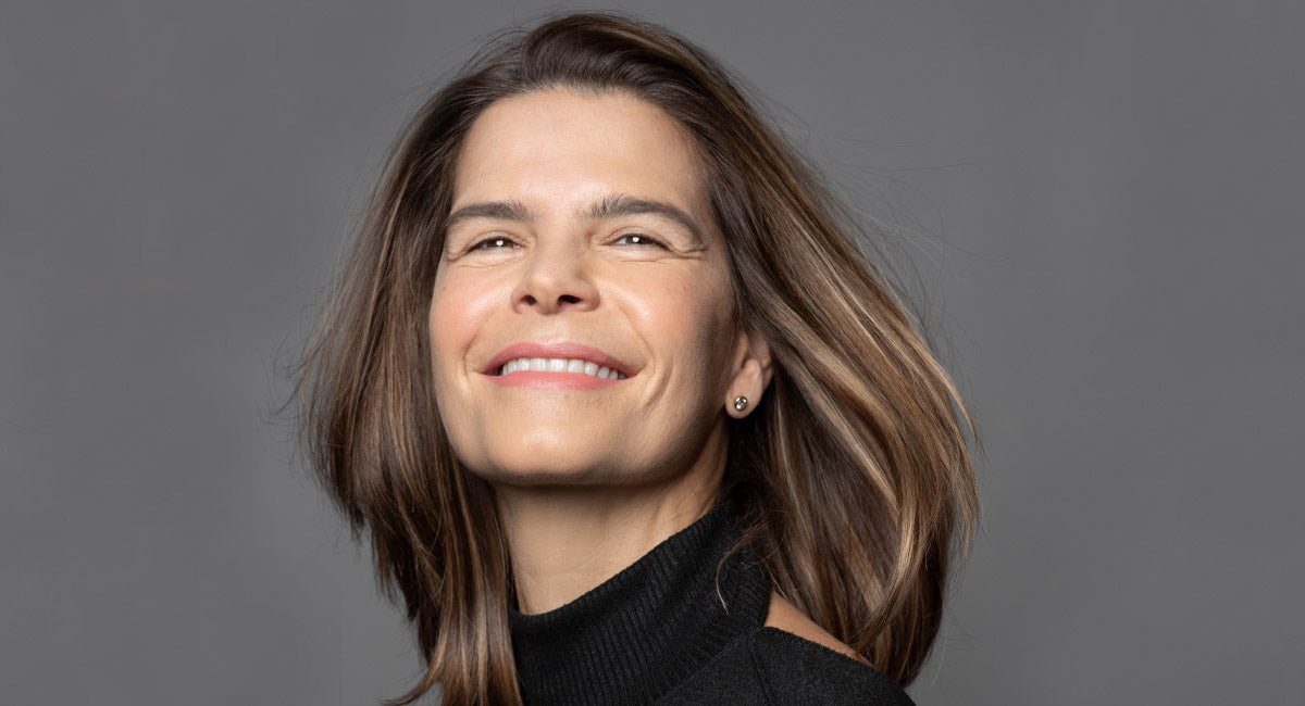 a woman over 40 years old feels happy about the deep conditioning benefits to her hair using better not younger's hair care.