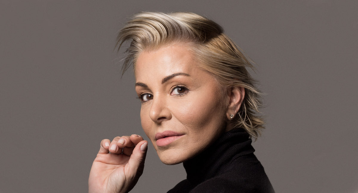 A Woman over 40 years old with beautiful short gray hair who feels fantastic about using hair serum for better hair health