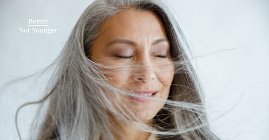 In this article about 7 Ways to Protect Your Hair from Wind Damage, Better Not Younger features a beautiful mature asian woman with long gray hair blowing in the wind and closing her eyes. 