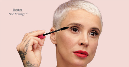 Better Not Younger features on "Grow The Latest Eyebrow Trend: Full and Natural", a beautiful mature woman with white silver hair styling her full natural brows with a growth brow serum.