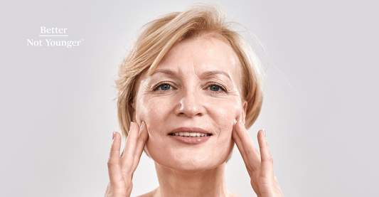 A caucasian woman touching her face skin as a sign of well hydrated slastic skin.