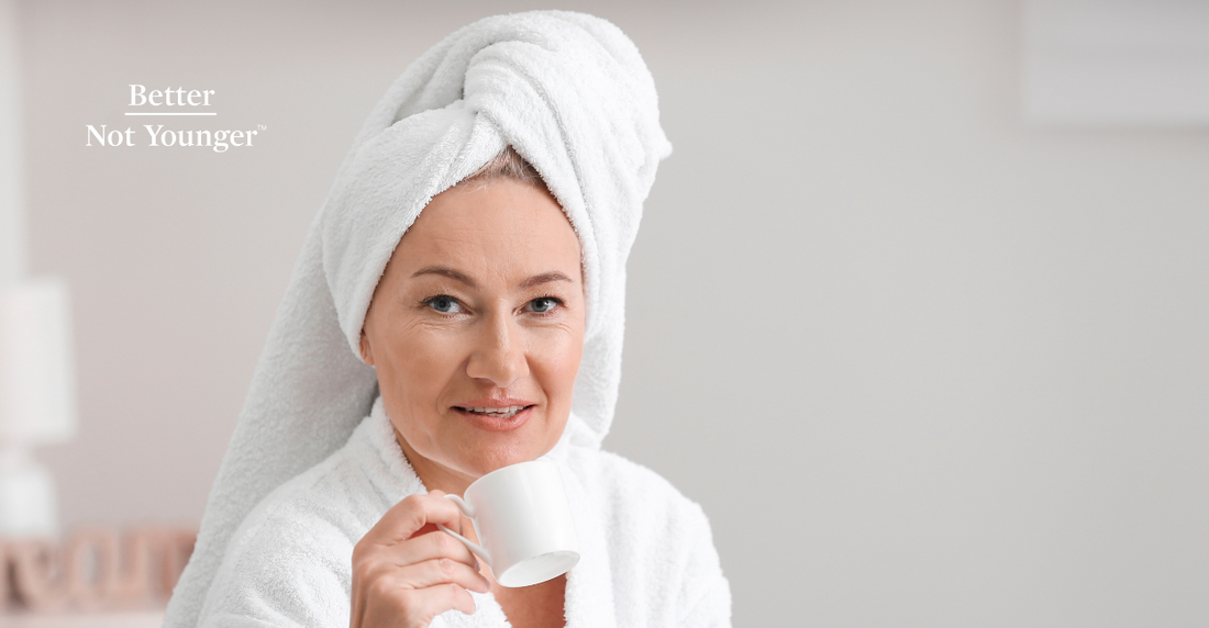 Better Not Younger features on "How To Refresh Hair Without Washing Like a Pro", a beautiful mature woman with a towel on her hair while drinking a cup on coffee. 