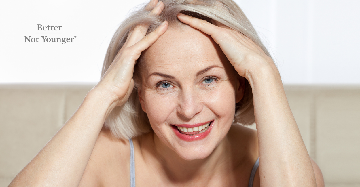 Better Not Younger features a mature woman touching her short blonde straight hair and smiling while looking at the camera. 