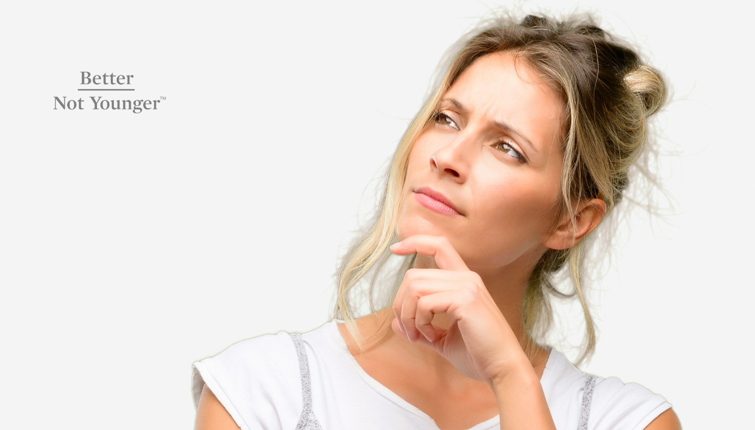 A woman thibking about The Difference Between Hair Shedding and Hair Loss