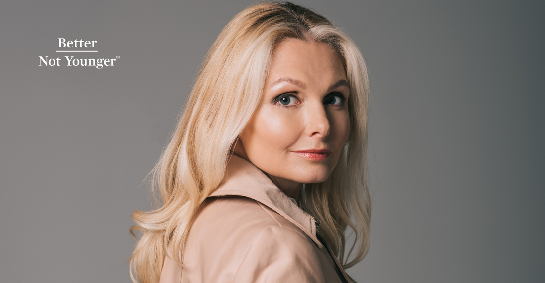 In this article How To Dye and Style Your Hair For Winter, BNY features a blonde mature woman with long hair wearing a winter coat while looking at the camera. 