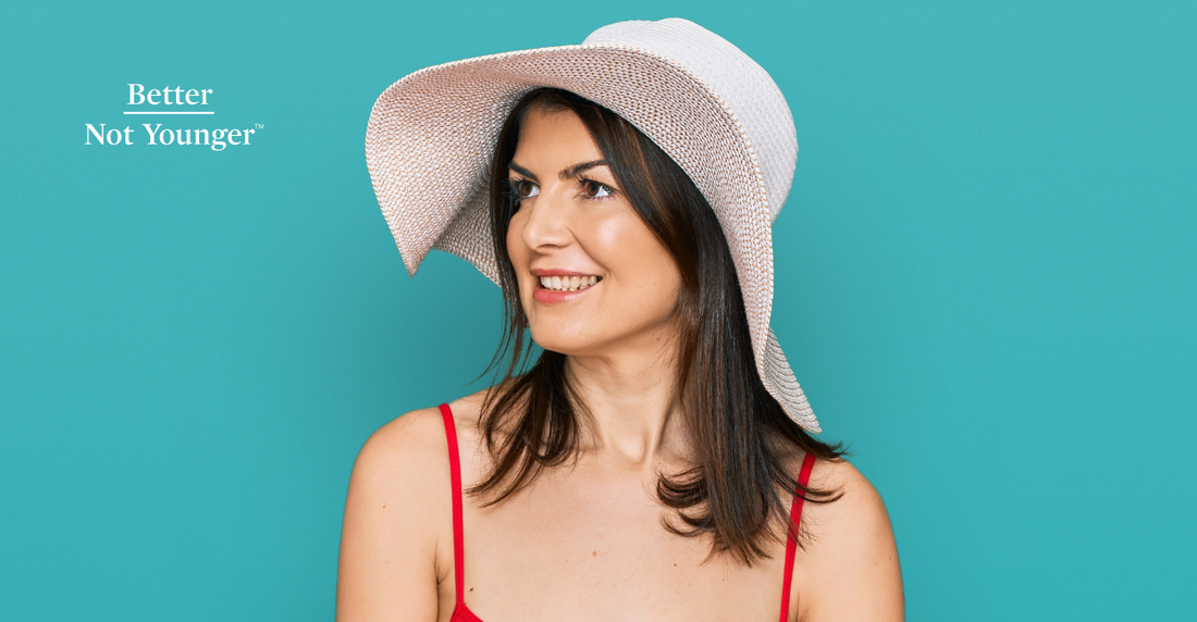 BNY features a woman with medium lenght brown hair wearing a white hut on a green background to illustrate this article on how to protect hair and scalp from the sun.