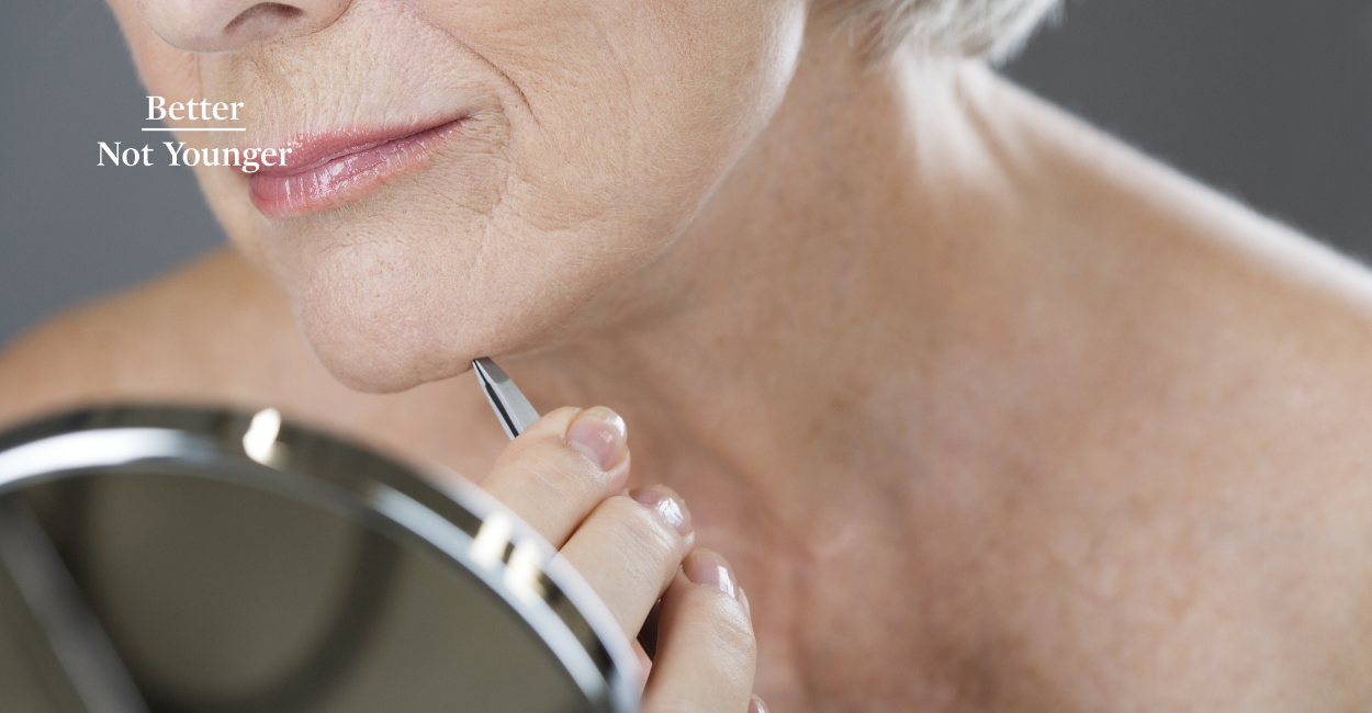A woman over 40 plucking facial hair growth at home before knowing other solutions for manopause related facial hair growth.