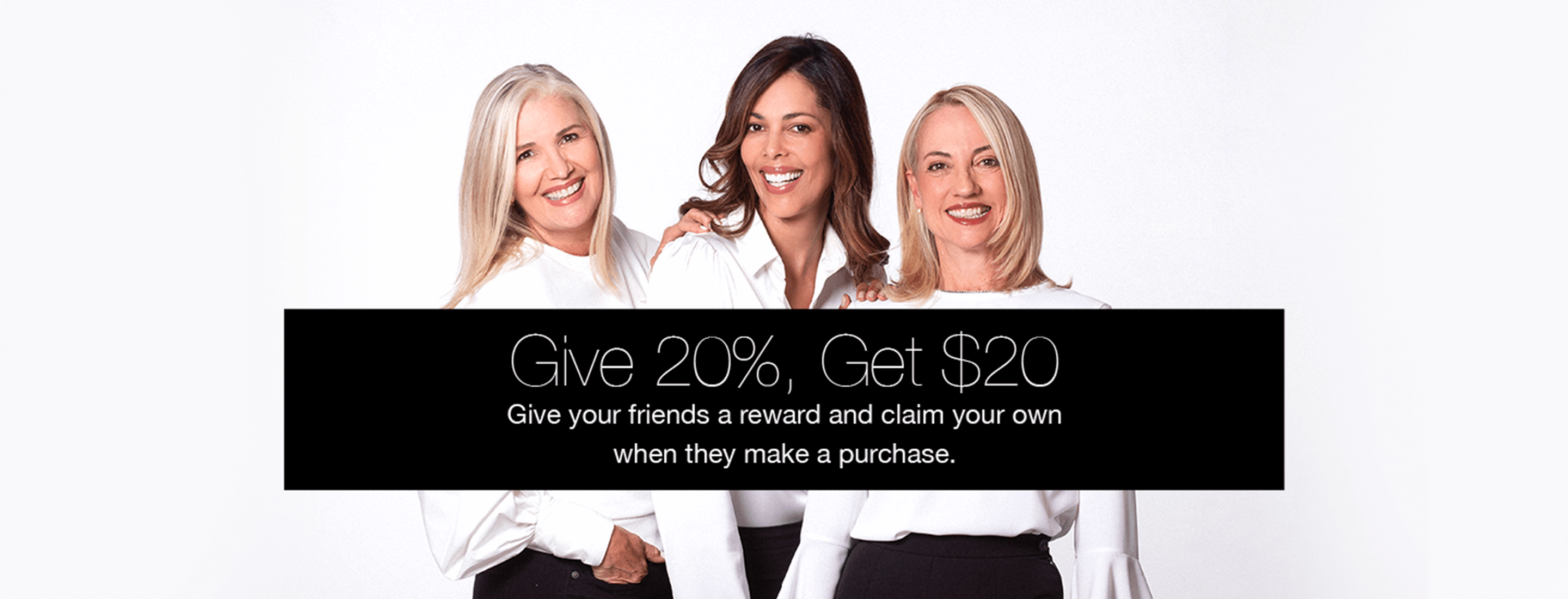 Three women standing together with a promotional banner offering a 20% discount for referrals.